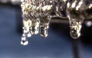 Icicles with crystal-clear drops of water glistening in the sunlight